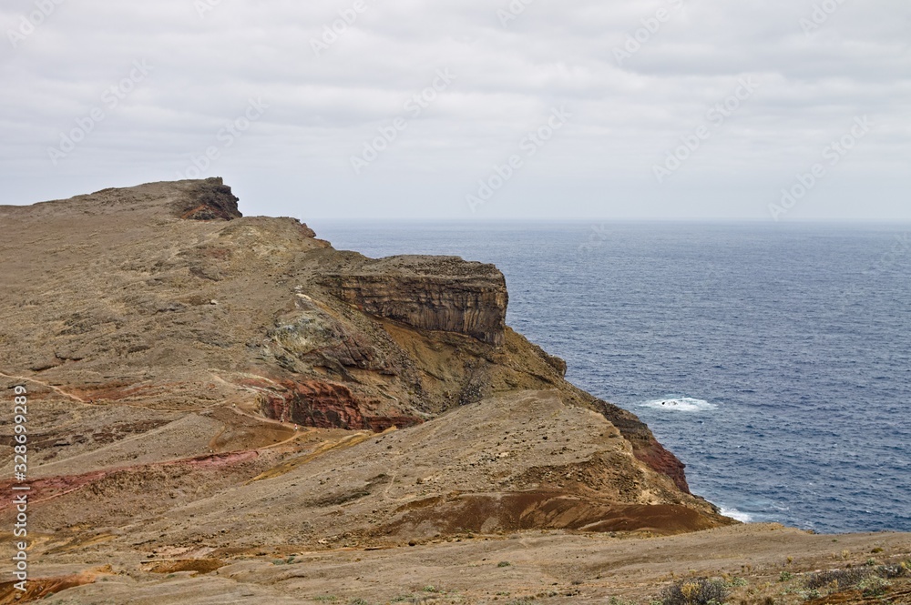 Panoramic view of an arid cliff landscape with trekking pathways in the Atlantic Ocean (Madeira, Portugal, Europe)