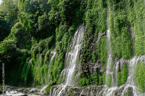 Fototapeta Naklejka Na Ścianę i Meble -  Beautiful and scenic view of Asik-asik Falls in Alamada, Cotabato, Philippines. Water from this waterfalls comes directly from the wall of a towering mountain.