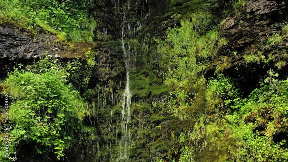 Clean small waterfall in the forest. Beautiful Nature Norway natural landscape. Clean small waterfall in the forest. Beautiful Nature Norway natural landscape.