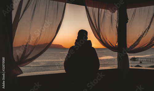 Silhouette of a man and sea view from the viewing gazebo