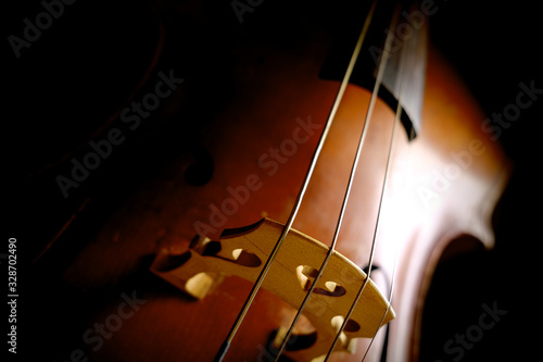 фотографія Vintage cello on a dark background. Cello details.