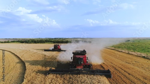 Aerial of two combine harvester cutting wheat