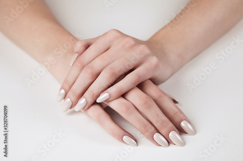 Women  s hands with beautiful manicure on a white background