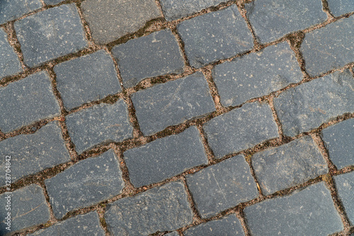 Background image of texture of a pedestrian road paved with paving stones