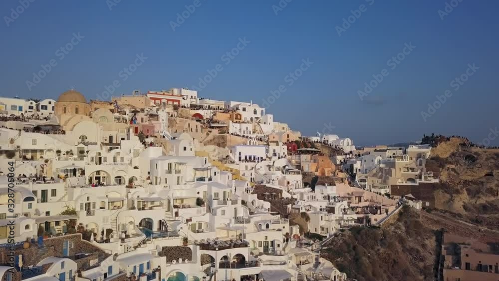 People watch for sunset on terraces of famous Oia town, Santorini island, Greece People watch for sunset on terraces of famous Oia town, Santorini island, Greece
