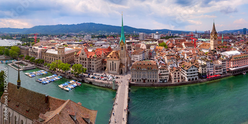 Aerial panorama of Zurich Old town with famous Fraumunster, St Peter churches and river Limmat from Grossmunster Church, Switzerland