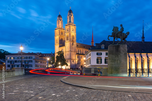 Famous Grossmunster churche along river Limmat at night in Old Town of Zurich  the largest city in Switzerland