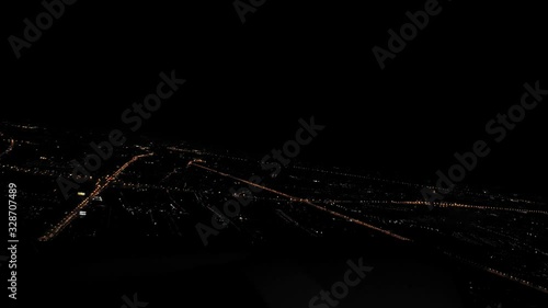 Airplane takes off from Kiev International Airport at Boryspol during night, seen from the plane window. photo