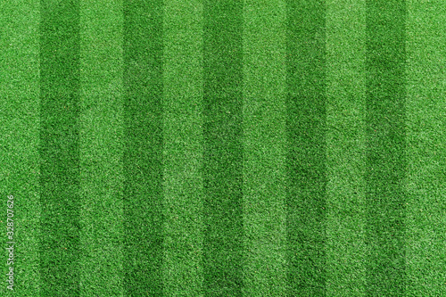 Top view stripe grass soccer field. Green lawn pattern background © banphote