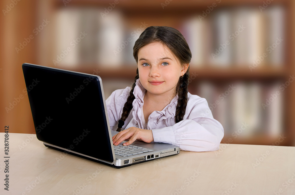 little cheerful girl in glasses with a computer laptop. Science, school, entertainment little cheerful girl in glasses with a computer laptop. Science, school, entertainment