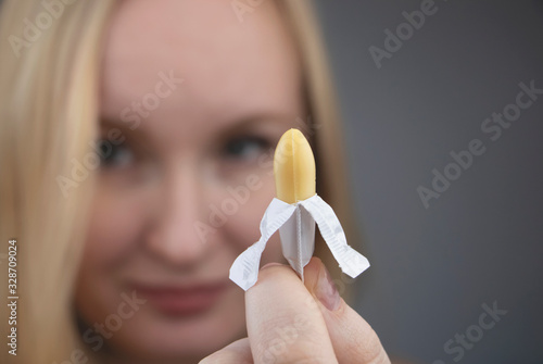 Fotografía Vaginal or rectal suppository in the hands of a woman