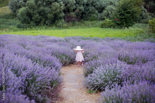 Little girl running at lavender field.