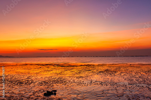 Beautiful summer beach and sea and yellow orange sky at the sunset  twilight period which including of sunrise