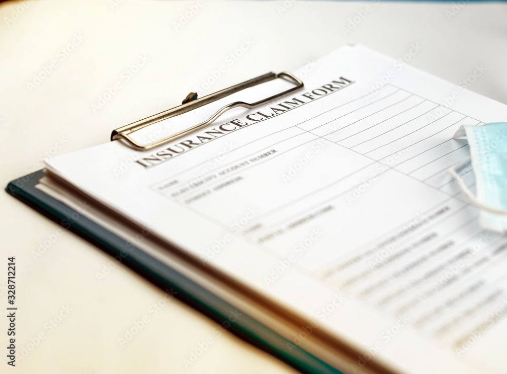 Blurred Insurance Claim Form put on table,blurry light around Blurred Insurance Claim Form put on table,blurry light around