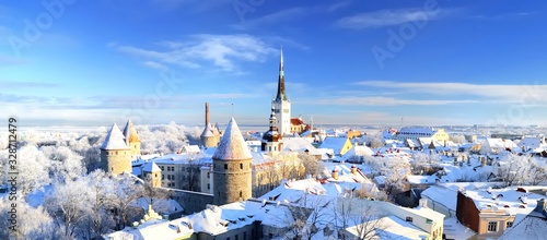 Panoramic view of the Tallinn old town on a clear winter day. Snow-covered trees and roofs. Estonia