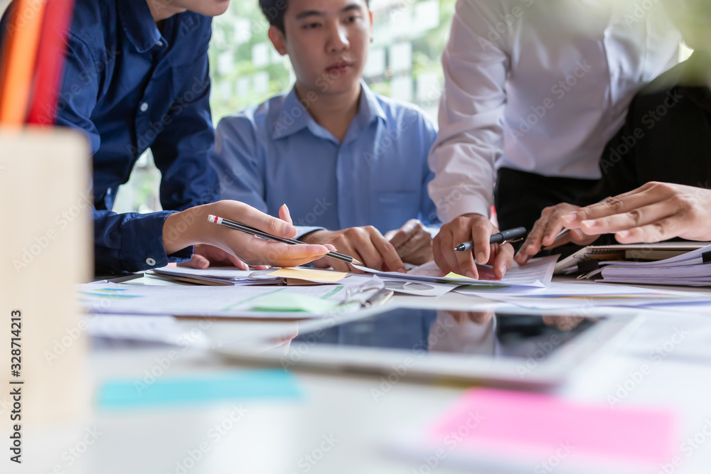 Group of young creative asian business men discussing job offers for the company and planning marketing strategy.