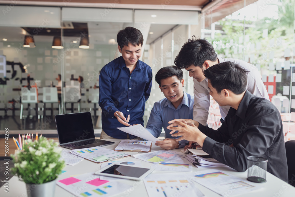 Group of young creative asian business men discussing job offers for the company and planning marketing strategy. Group of young creative asian business men discussing job offers for the company and planning marketing strategy.
