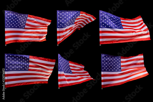 A set of American flags developing in the wind, isolated on a black background.