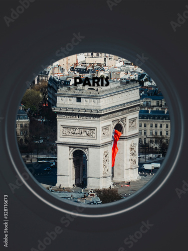 Arc de Triomphe seen through a circular window labeled Paris photo