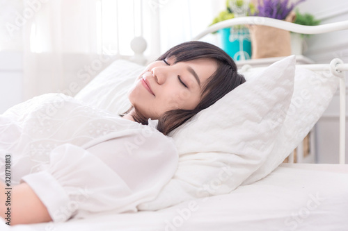 Portrait of beautiful asian young woman sleep lying in bed with head on pillow comfortable and happy with leisure, girl with relax for health and lifestyle concept.