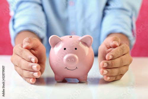 Boy holding piggy bank for savings