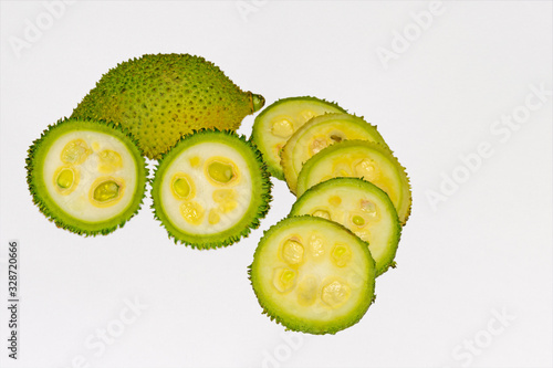 Fresh green colorful spiny gourd vegetables on white background. photo