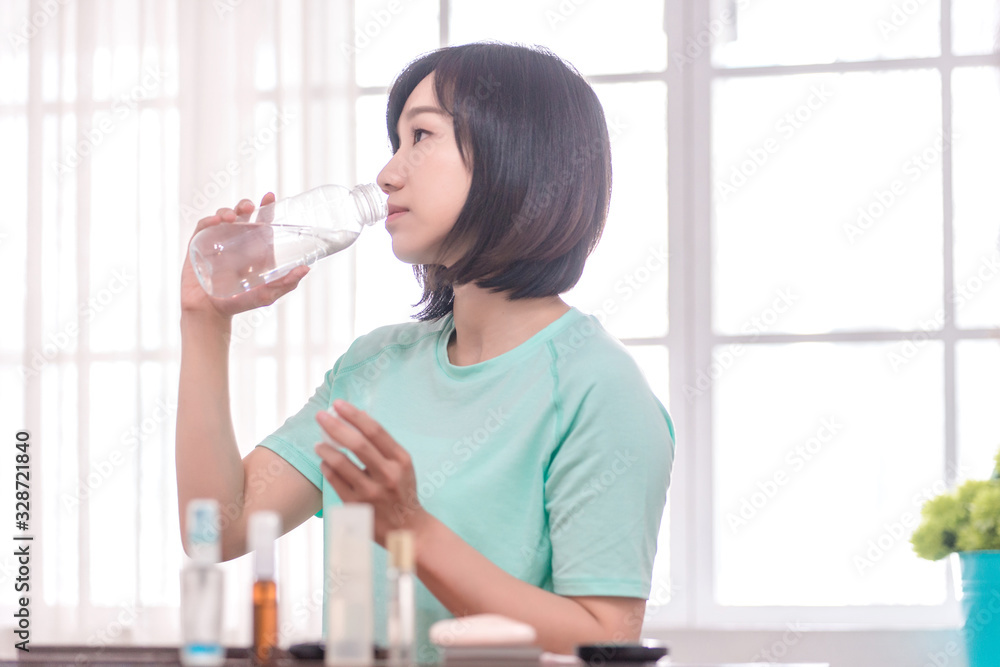 young attractive asian woman who drinks water young attractive asian woman who drinks water