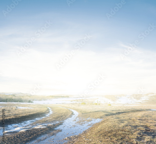 spring field with dirty pond at the early morning