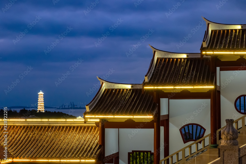 Obraz premium Towers with lights on at night and buildings in temples