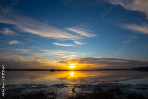 dramatic sunset over the quiet lake  evening natural background