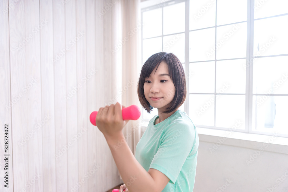 Beautiful Asian girl, Fit sportswoman exercising and training at home Beautiful Asian girl, Fit sportswoman exercising and training at home