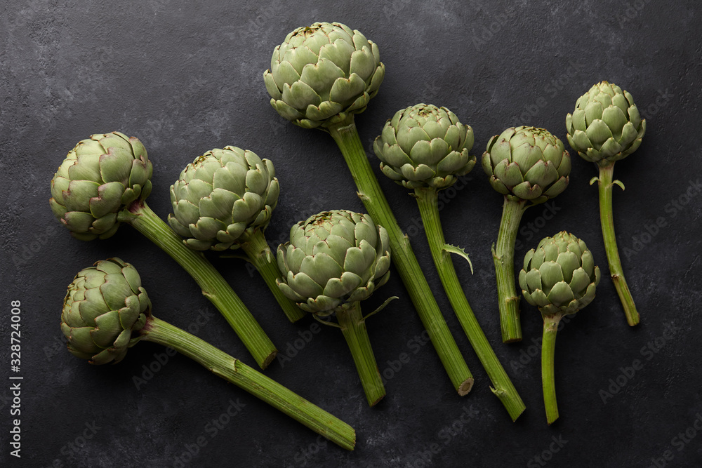 Fresh green artichokes on black background Fresh green artichokes on black background