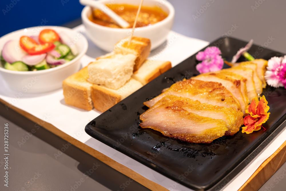 Pork satay grilled with Thai spices and peanut sauce and toast in the restaurant. Pork satay grilled with Thai spices and peanut sauce and toast in the restaurant.
