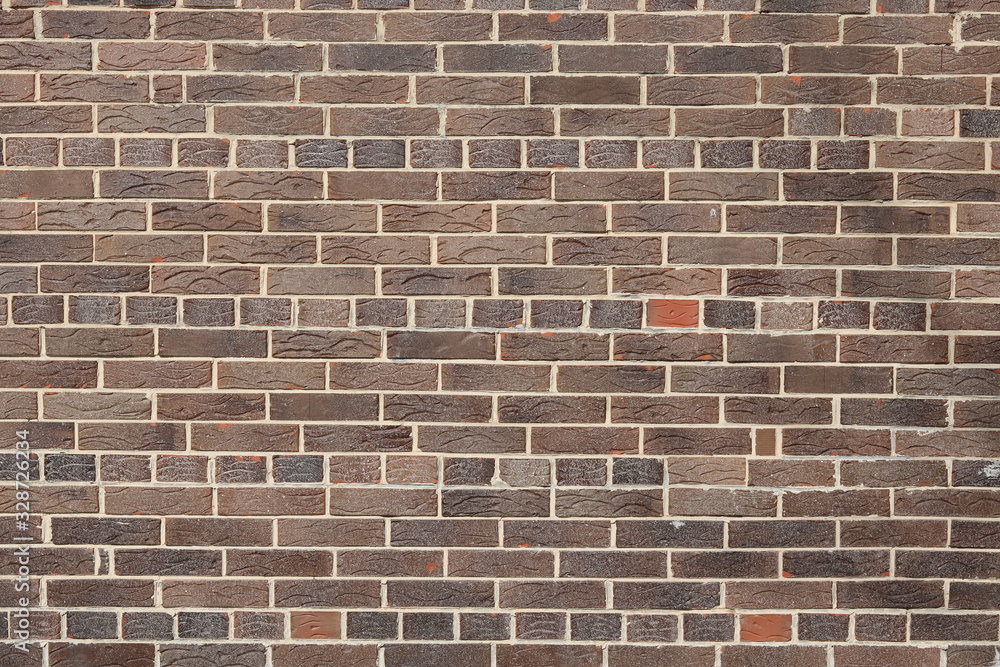 Brown background of beautiful unusual building brick Brown background of beautiful unusual building brick
