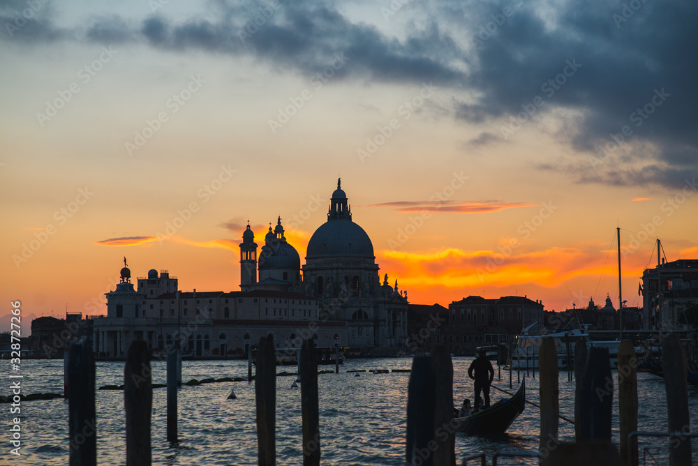 View of the Grand Canal and Basilica di Santa Maria della Salute in Venice during sunset.