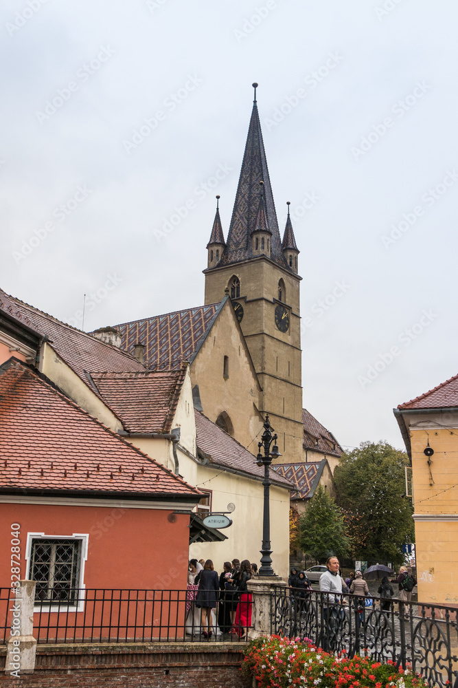 Fragment of Small Square with clocktower of Lutheran Cathedral of Saint Mary in a rainy day in Sibiu city in Romania