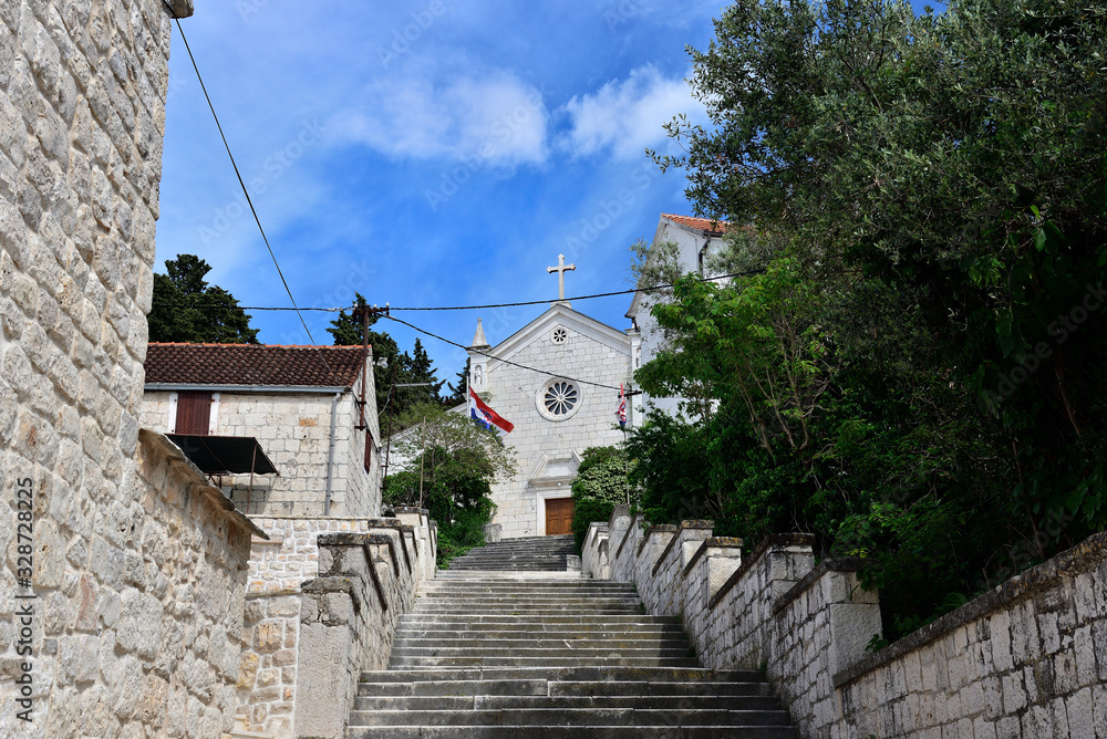 The parish church of the Assumption of the Blessed Virgin Mary in town of Rogoznica on sunny spring day, Dalmatia, Croatia