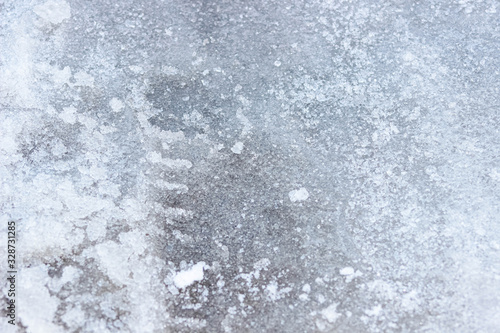 Ice on the road , the texture of a slippery road. Background, macro photography .