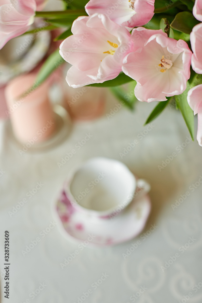 Decor and spring table setting is a vase with pink tulips Decor and spring table setting is a vase with pink tulips