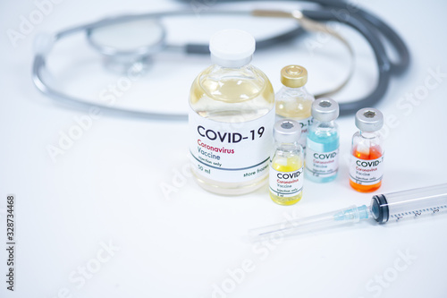 Vaccine bottles, syringe and stethoscope on white background.Vaccination against coronavirus quarantine or covid-19.Protection against virus and infection control.Medication treatment concept.