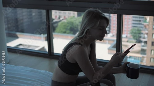 Wallpaper Mural Millennial woman in casual clothing drinking hot caffeine beverage and messaging in social networks during morning time, Caucasian female booking tickets and checking delivery tracking Torontodigital.ca