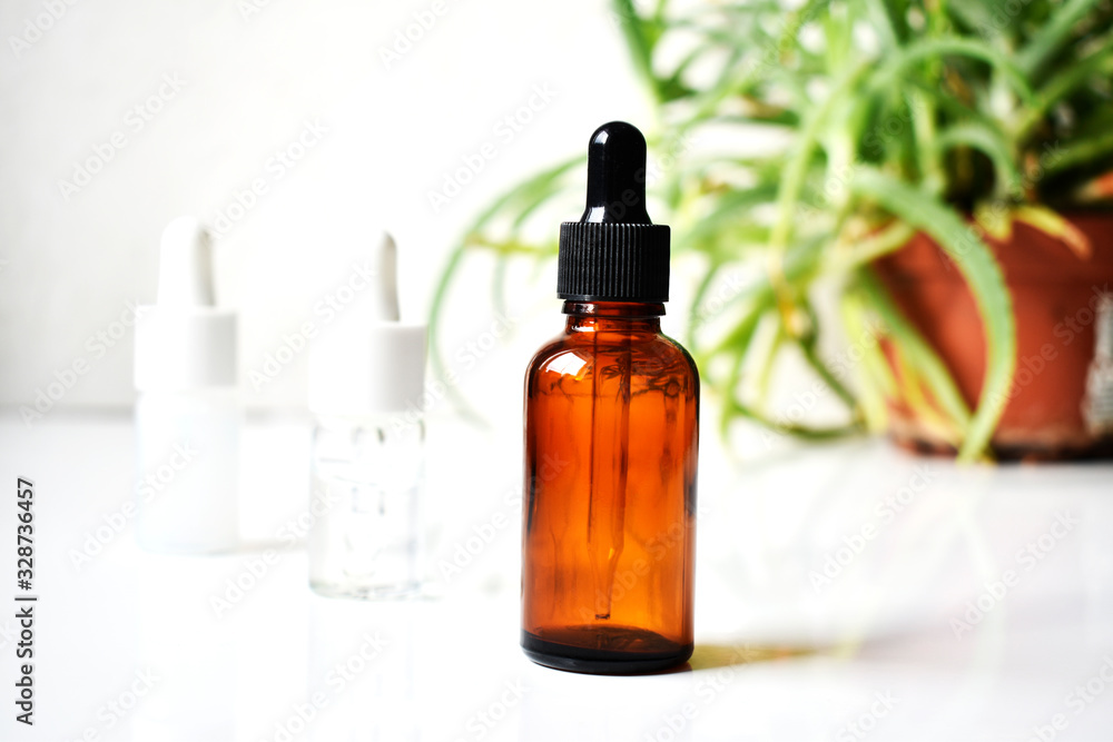 Various glass bottles for cosmetics, natural medicine , essential oils or other liquids on a white background, top view. Organic Various glass bottles for cosmetics, natural medicine , essential oils or other liquids on a white background, top view. Organic
