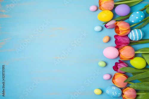 Wallpaper Mural Easter holiday background with easter eggs and tulip flowers on wooden table