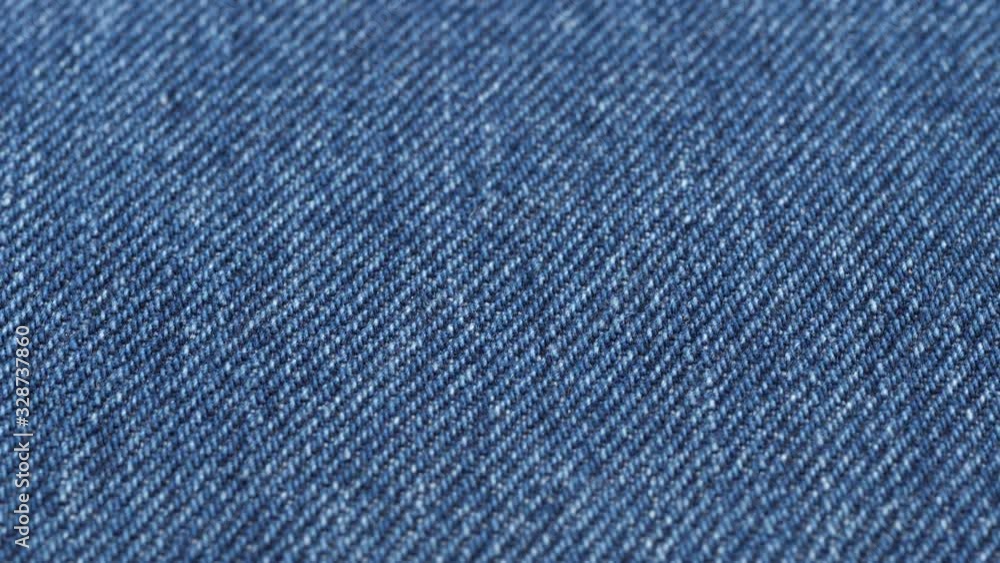 Jeans fabric close up tracking. Denim textile texture. Slider shot. Low angle, macro. 4K, 422 10 bit Jeans fabric close up tracking. Denim textile texture. Slider shot. Low angle, macro. 4K, 422 10 bit