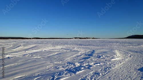 Landscape on the banks of the frozen lake