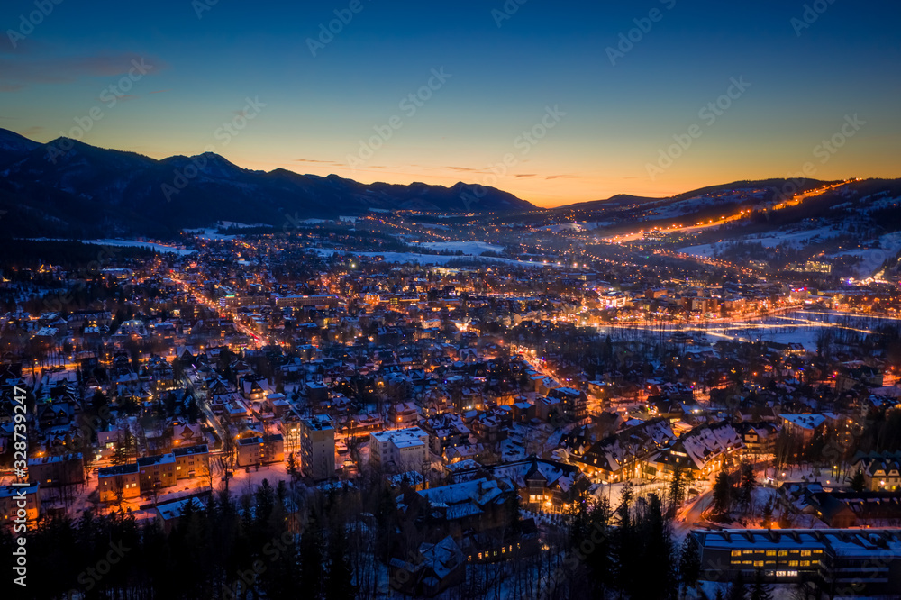 Amazing illuminated Zakopane city in winter at night, aerial view