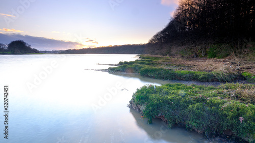 Hamble, UK - January 28, 2020:  The river Hamble at sunset from the bank in Manor Farm Country Park, Hampshire, UK