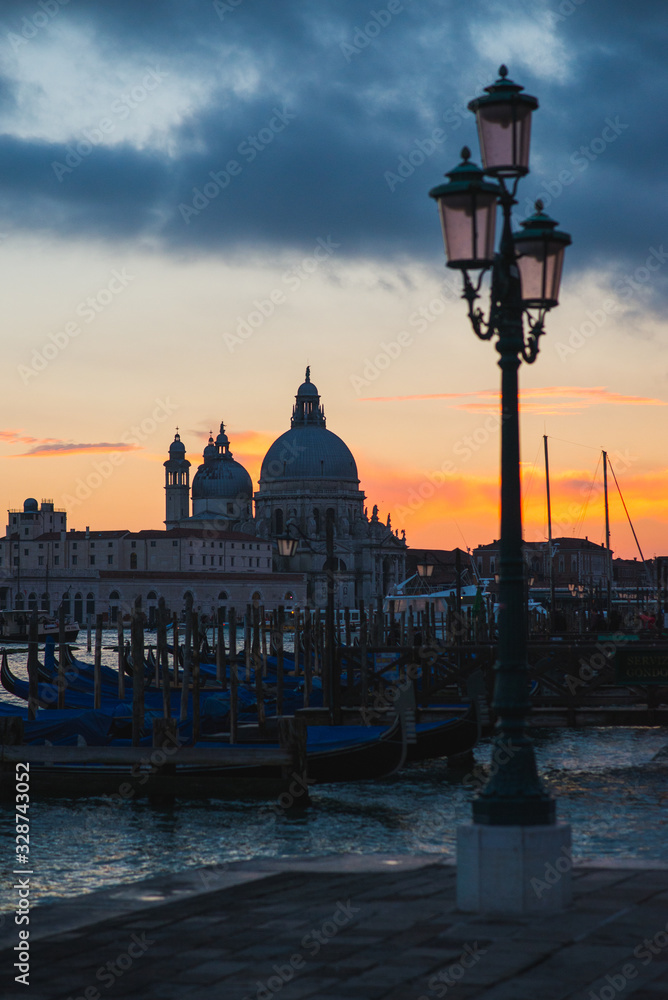 View of the Grand Canal and Basilica di Santa Maria della Salute in Venice during sunset.