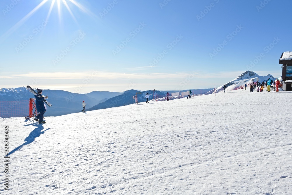  vacationers on a plateau of a ski resort during sunset