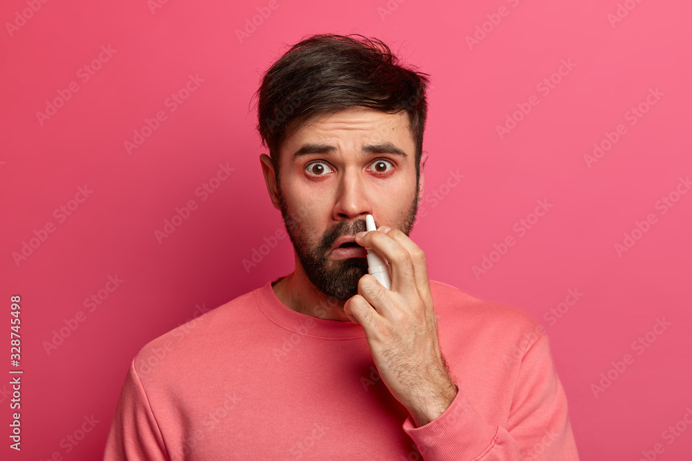 People, cold symptoms and medication concept. Unhappy sick man uses